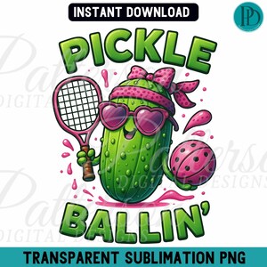 May include: A cartoon pickle wearing pink sunglasses and a headband, holding a pink tennis racket and a pink basketball. The pickle is green and has a happy expression. The text "Pickle Ballin'" is written in green letters below the pickle.