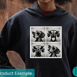 May include: A black hoodie with a graphic print of four dachshunds wearing sunglasses. The dachshunds are in a grid pattern, with each dachshund facing a different direction. The graphic is in black and white.