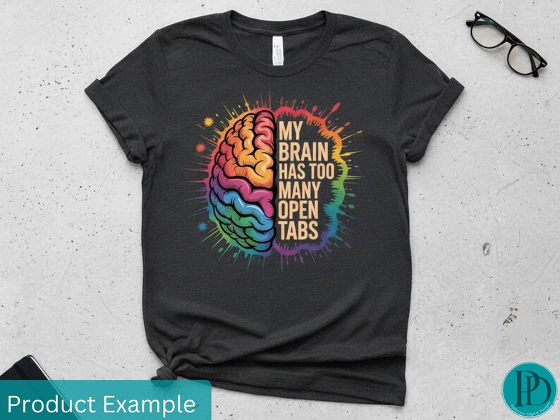 May include: Dark gray t-shirt with a colorful brain graphic. The brain is split into two halves, with one side in warm colors and the other in cool colors. Text reads "MY BRAIN HAS TOO MANY OPEN TABS".