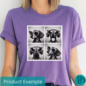 May include: A purple t-shirt with a graphic of four dachshunds wearing sunglasses. Each dachshund is in a separate square. The dachshunds are black and white.