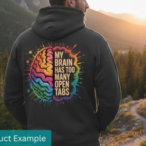 May include: Black hoodie with a colorful brain graphic and the text "MY BRAIN HAS TOO MANY OPEN TABS." The brain illustration features rainbow colors. The hoodie is a casual garment, suitable for everyday wear.