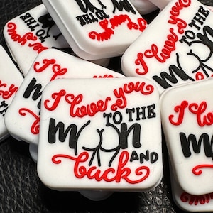 May include: White square tiles with red and black lettering. The tiles say "I love you to the moon and back".