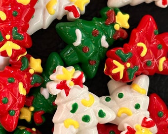 May include: Assortment of Christmas tree-shaped buttons in red, green, and white with yellow and green accents. The buttons are decorated with dots, stars, and bows.