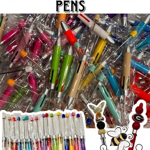 May include: Multi-ink beadable pens in a variety of colors, including pink, blue, green, yellow, and orange. The pens have a silver metal body and a clear plastic tip. The pens are arranged in a plastic bag and are ready to be beaded.