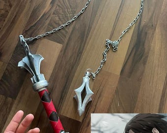 May include: A silver-colored chain weapon with a red and black leather handle. The weapon has a spiked ball at the end of the chain. The weapon is on a wooden surface. A character from an anime is shown in the background.