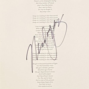 May include: A white paper sheet featuring printed black lyrics to the song Rockin' in the Free World, including lines like There's a lot of people saying and We got a thousand points of light, overlaid with a large, dark, handwritten signature.