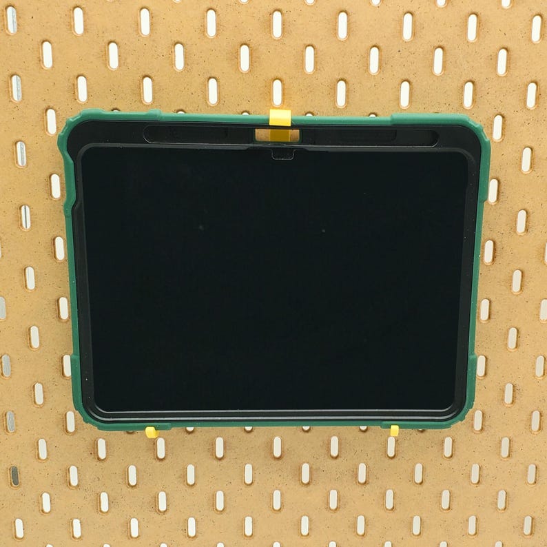 May include: A green tablet case with a black screen. The case has a yellow tab on the top.