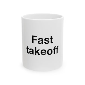 May include: A white ceramic mug featuring the black text Fast takeoff printed in a simple sans-serif font on the front. The mug has a cylindrical shape with a smooth finish and a standard handle-free appearance from this specific angle.