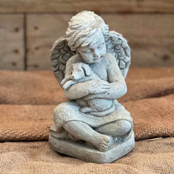 Angel holding top dog figurine
