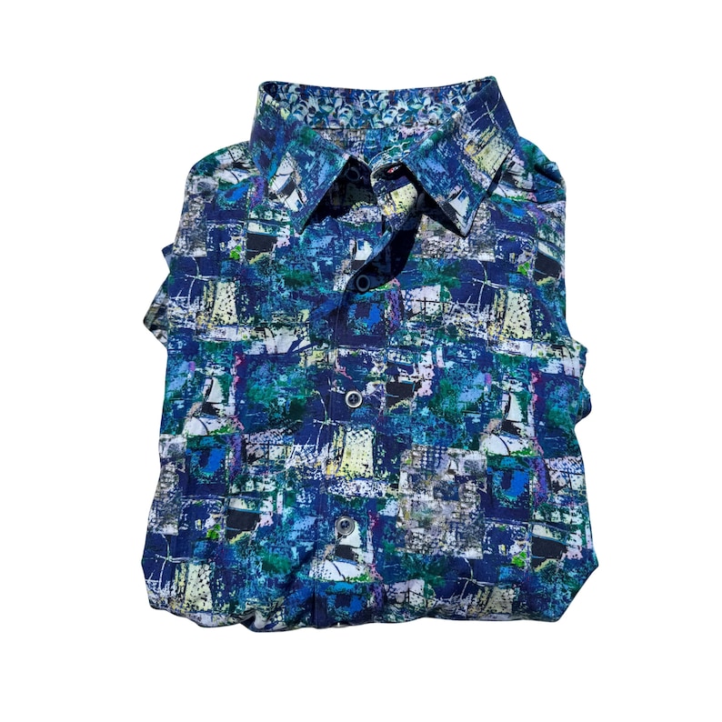 May include: Folded button-down shirt with a vibrant abstract pattern in shades of blue, green, and white. The shirt features a classic collar and button closure. The interior collar lining has a decorative pattern.