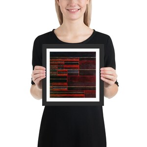 Pode incluir: Uma impressão de arte abstrata emoldurada com um design geométrico de listras e retângulos vermelhos, pretos e brancos.