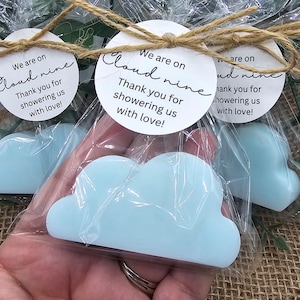 May include: A blue cloud-shaped soap bar with a white tag that reads "We are on Cloud nine Thank you for showering us with love!"