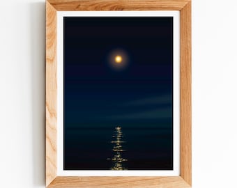 May include: A framed photograph of a full moon reflecting on the water at night. The moon is a bright yellow colour and the water is dark blue.