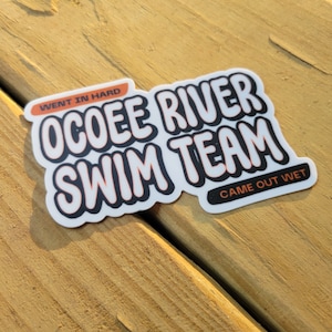 May include: White sticker with black and orange text that reads "Went in hard" "Ocoee River Swim Team" "Came out wet".