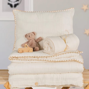 May include: A set of three ceramic mugs with a speckled, cream-colored glaze. Each mug features a different hand-painted floral design in shades of blue, green, and yellow. The mugs have a simple, modern shape with a comfortable handle.