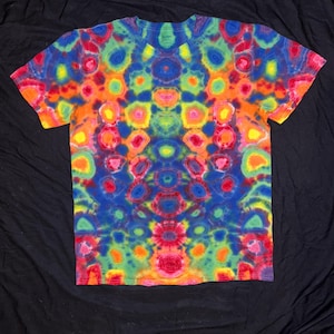 May include: A colorful tie-dye t-shirt with a crew neck and short sleeves. The shirt features a vibrant pattern of blues, greens, oranges, and reds. The tie-dye design is symmetrical, creating a visually appealing and psychedelic effect. The shirt is made of a soft material.