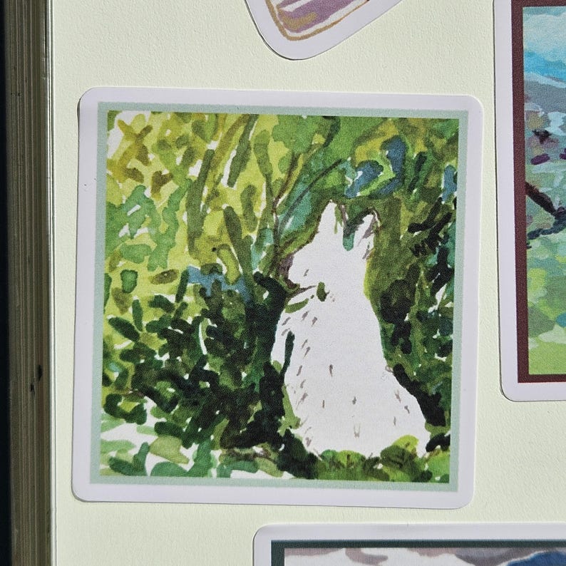 May include: A watercolor painting of a white rabbit sitting in a green bush. The rabbit is facing away from the viewer and looking up. The bush is made up of many small green leaves.