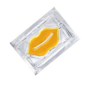 May include: A single-use lip mask in a silver foil sachet. The mask is a bright yellow, lip-shaped hydrogel. The sachet is sealed and has a clear, transparent appearance, with the lip mask visible inside. The background is white.