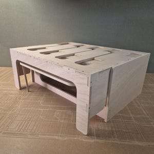 May include: A light wood, rectangular storage box with a hinged lid and multiple compartments. The box is made of plywood and has a natural wood finish.