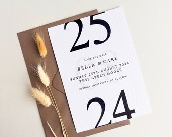 May include: White save the date card with black text. The card features the date "25" in large bold font, followed by the text "Save the Date", "Bella & Carl", "Sunday 25th August 2024", "This Green Moore", and "Formal Invitation to Follow". The card also features the number "24" in large bold font.