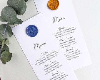 May include: Two white cards with a menu for a wedding or special event. The cards are decorated with wax seals, one blue and one gold. The menu lists a starter, main course, and dessert. The starter is grilled fillet with red onion, served with baby potatoes, carrots, green beans and curly kale. The main course is herb roasted lamb and rice with fresh basil, spring vegetable risotto. The dessert is dark chocolate cake, selection of ice creams, sticky toffee pudding with vanilla ice cream.