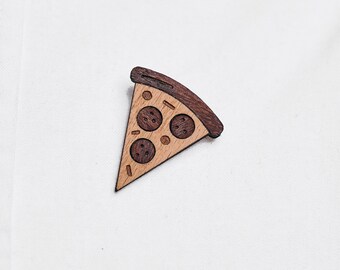 Piece of pizza as a pin, badge, brooch made of wood for a celebration or festival