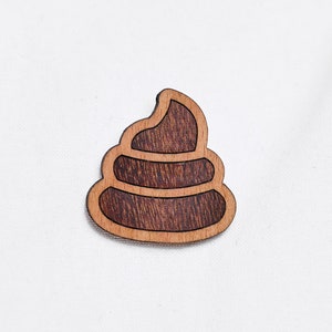Piles of excrement as a pin, badge, brooch made of wood for a celebration or festival image 1