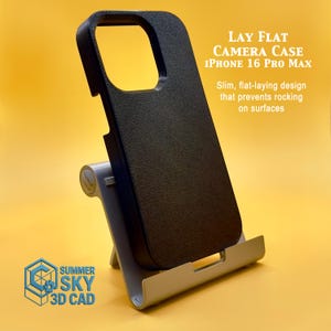 May include: A black iPhone 16 Pro Max camera case with a textured surface, displayed on a gray stand against a yellow background. The case has a slim, flat-laying design. Text on the image reads "LAY FLAT CAMERA CASE IPHONE 16 PRO MAX".