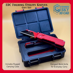 May include: A red and black EDC folding utility knife set in a black carrying case. The open case reveals a red utility knife with a black blade. The text "EDC Folding Utility Knives Gift Set" is at the top. The case includes the text "Includes Rugged Carrying Case" and "Compact Work Knife for Everyday Carry".