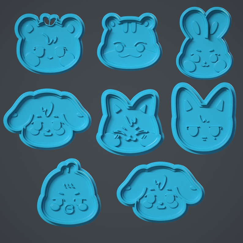 May include: Nine blue plastic cookie cutters shaped like different animals. The cutters are in the shape of a bear, a tiger, a rabbit, a dog, a cat, a fox, a bird, a puppy, and a kitten.