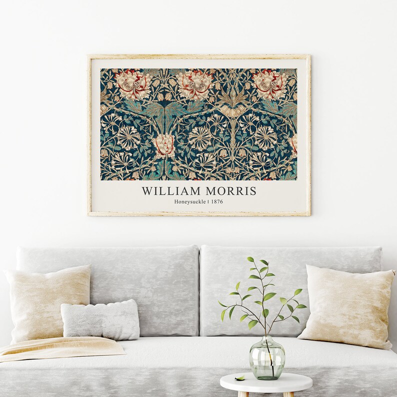 May include: A framed print of a vintage floral pattern in shades of green, white, and red. The print is titled "WILLIAM MORRIS" with the text "Honeysuckle | 1876" below the title.