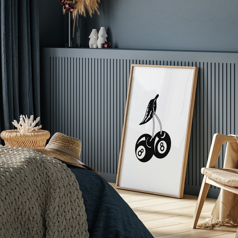 May include: Black and white illustration of a cherry with two eight ball pool balls as the cherries. The illustration is framed and hanging on a wall.