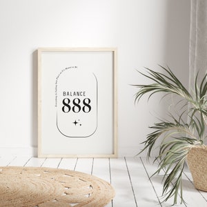 May include: A framed print with a white background and black text. The text reads "Everything is Falling into Place as it's Meant to Be. Balance 888". The text is inside a rounded rectangle with two small stars below it.