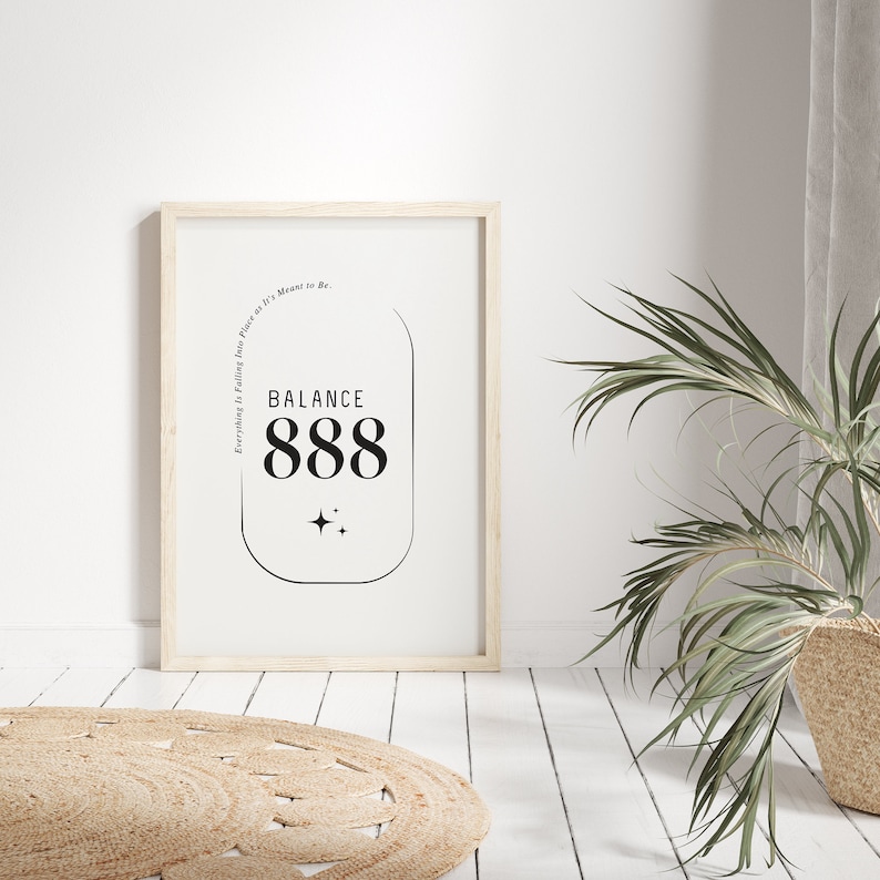 May include: A framed print with a white background and black text. The text reads "Everything is Falling into Place as it's Meant to Be. Balance 888". The text is inside a rounded rectangle with two small stars below it.