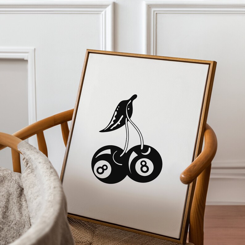 May include: Black and white illustration of a cherry with a stem and leaf. The cherry is made up of two 8-ball pool balls.