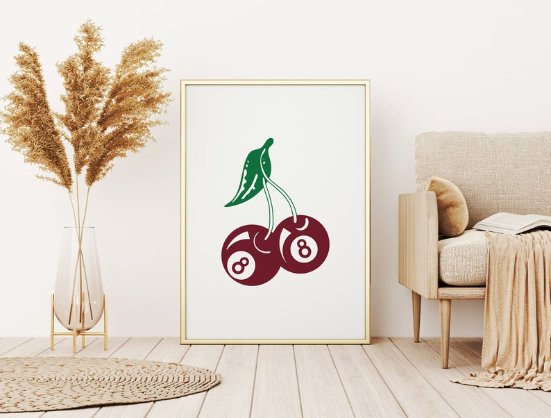 May include: A white framed print with a green and red illustration of two cherries. Each cherry is a billiard ball with the number 8 on it.