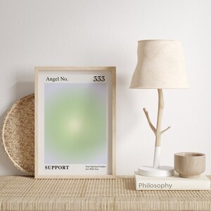 May include: A framed print with a light green and purple gradient background. The print features the text "Angel No. 333 SUPPORT" and "Your Spiritual Guides Are With You."