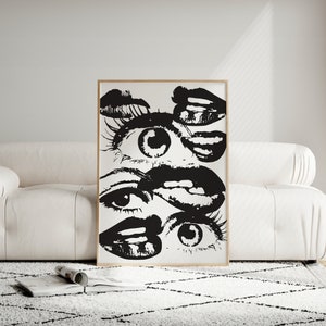 Puede incluir: Impresi&oacute;n de arte abstracto en blanco y negro con m&uacute;ltiples ojos y labios superpuestos. La impresi&oacute;n est&aacute; enmarcada en un marco de madera simple.