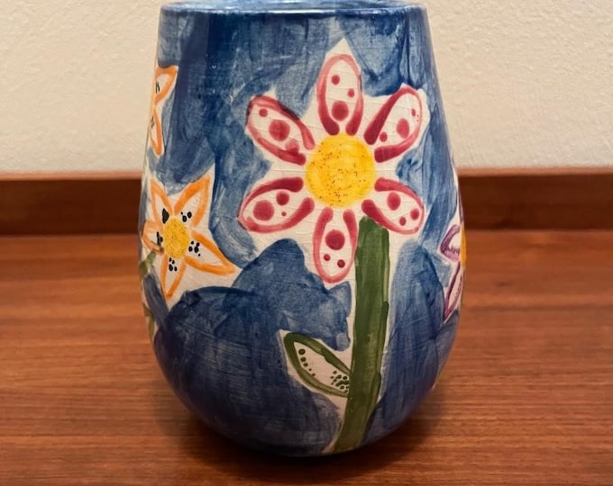 Bright fun colorful handmade hand painted blue ceramic vase with floral pattern