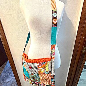 May include: A white ceramic mug with a black handle and the text "But First, Coffee" in a black, handwritten-style font. The mug is on a white surface.