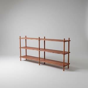 Puede incluir: Una estanter&iacute;a de madera larga de tres niveles con un acabado marr&oacute;n c&aacute;lido. La estructura consta de tres estantes horizontales sostenidos por postes cil&iacute;ndricos verticales en cada esquina y en el centro, creando un dise&ntilde;o abierto y estable.