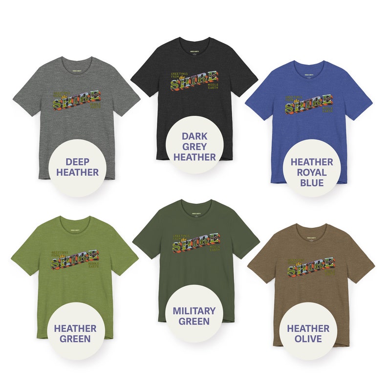 May include: Six t-shirts in different colors featuring a graphic of a vintage-style sign that reads "Greetings from The Shore" with a palm tree and a sun. The colors are deep heather, dark grey heather, heather royal blue, heather green, military green, and heather olive.