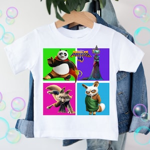 May include: White t-shirt with a colorful graphic of characters from the movie "Kung Fu Panda 4". The graphic features Po, Tigress, and two other characters in colorful squares.