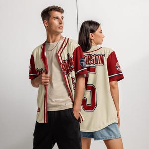 Models wearing vintage style Jackie Robinson baseball jersey at a baseball field