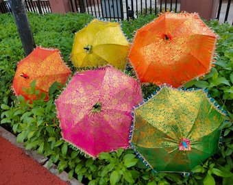May include: Five decorative umbrellas in bright colors including yellow, orange, pink, and green, each featuring a gold floral pattern and a fringed edge. The umbrellas are arranged together, and the text Street Bedsheet is visible.
