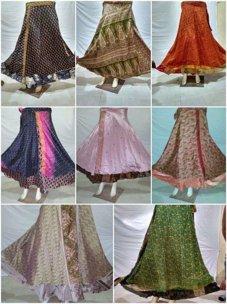 May include: A collection of eight floor-length wrap skirts featuring various patterns and colors, including black, green, orange, pink, and floral prints. Each skirt has a flared silhouette and is displayed on a mannequin to show the drape.