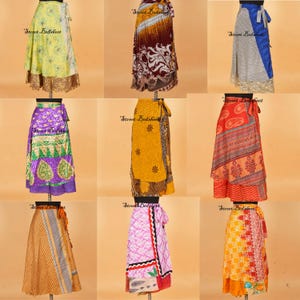 May include: A collection of nine wrap skirts displayed on mannequins, featuring various vibrant colors, intricate floral, paisley, and geometric patterns, with tie-waist closures and diverse fabric textures in a grid layout on a plain background.
