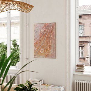 May include: A framed abstract painting with a light orange background and white dots and lines. The painting is in a modern style and would look great in a living room or bedroom.