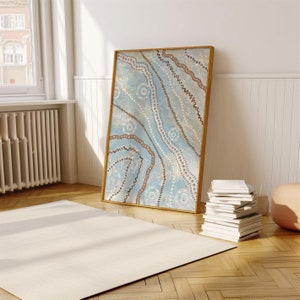 May include: A framed abstract painting with a blue background and brown and white patterns. The painting is in a wooden frame and is hanging on a white wall.
