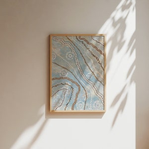 May include: A framed artwork with a blue background and brown and white patterns. The artwork features a series of wavy lines and dots.